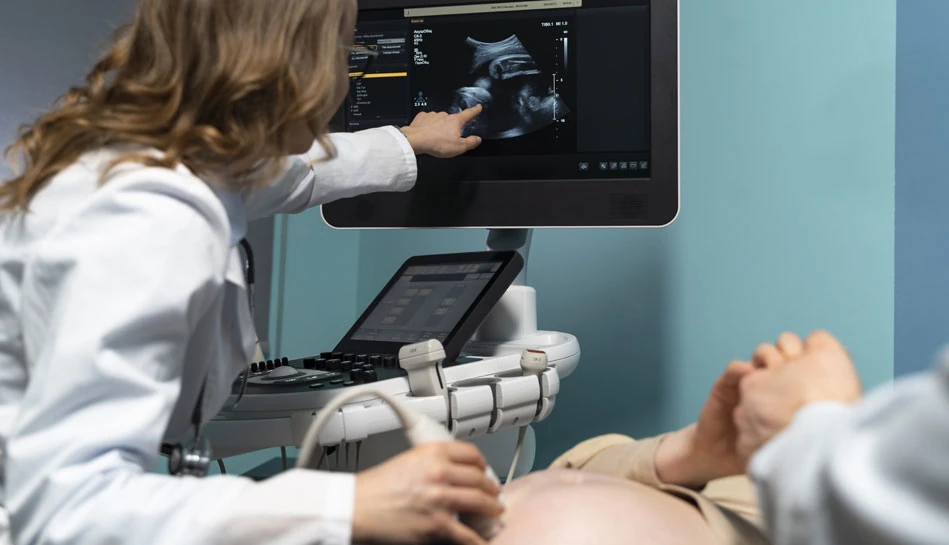 Doctor performing Doppler scan ultrasound to evaluate fetal blood flow during pregnancy